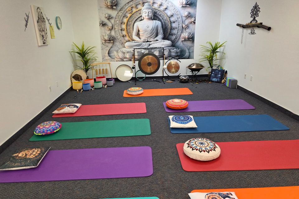 Yoga mats and cushions arranged in the studio