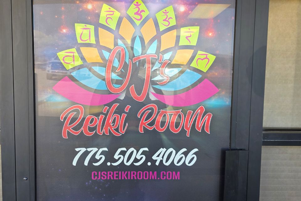 The front door of CJ's Reiki Room with its logo and phone number