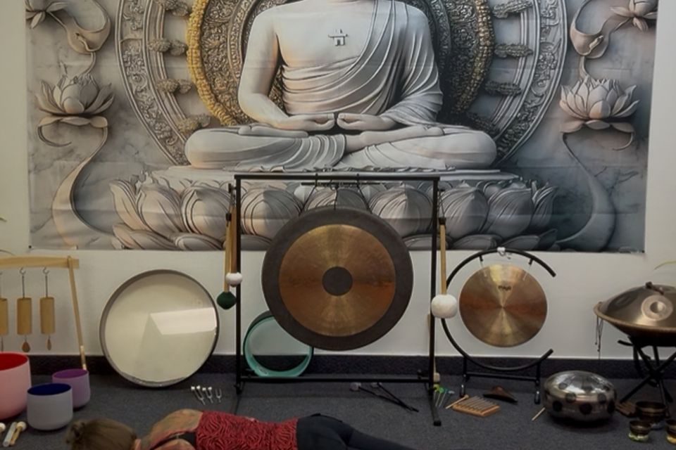 Gongs and drums set up in front of the studio's Buddha mural
